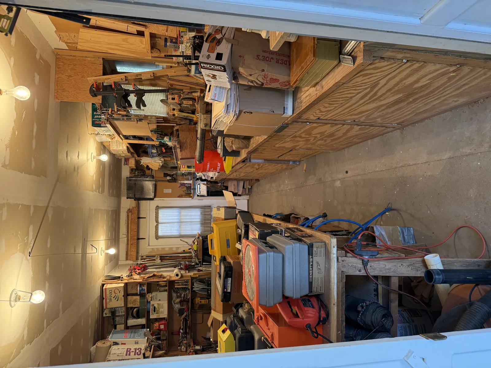 Packed workshop aisle with tools and workbenches